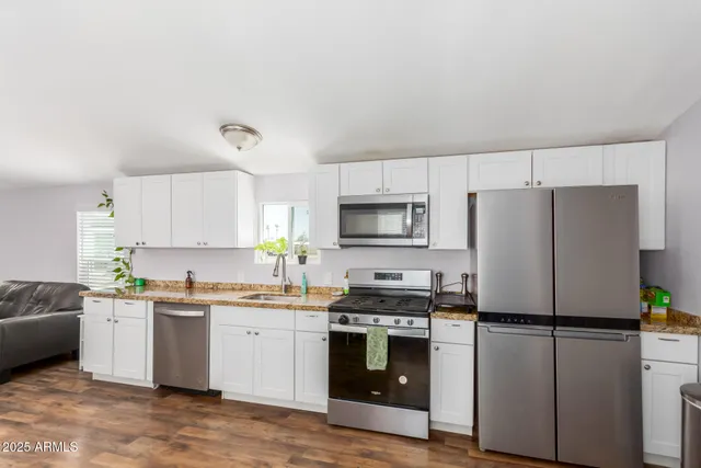 a kitchen with a white cabinets and white appliances