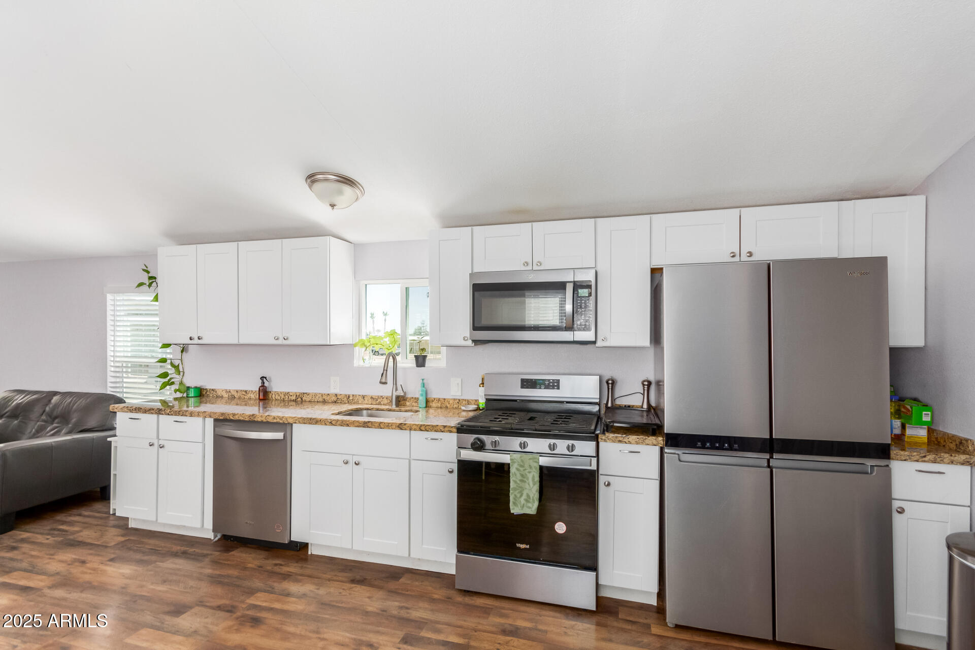 320 East McKellips Road, Unit 188 Mesa, AZ 85201 - Photo 12 of 28 a kitchen with a white cabinets and white appliances