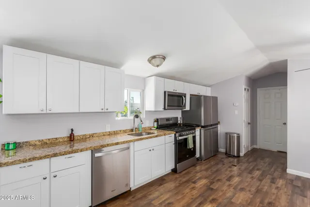 a kitchen with a sink stove and refrigerator