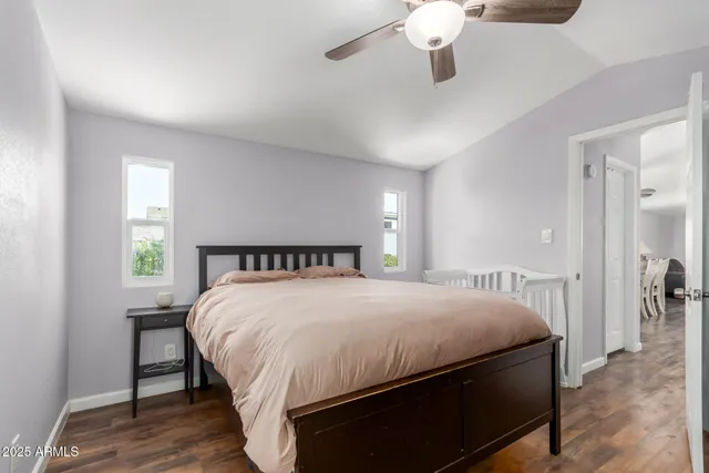 a bedroom with a large bed chandelier and a window