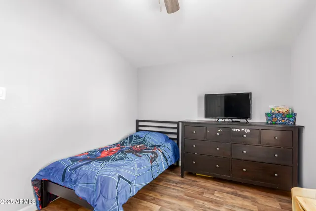 a bedroom with a bed and flat screen tv