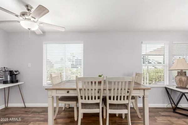 a view of a a dining room with furniture window and wooden floor