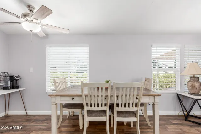 a view of a a dining room with furniture window and wooden floor