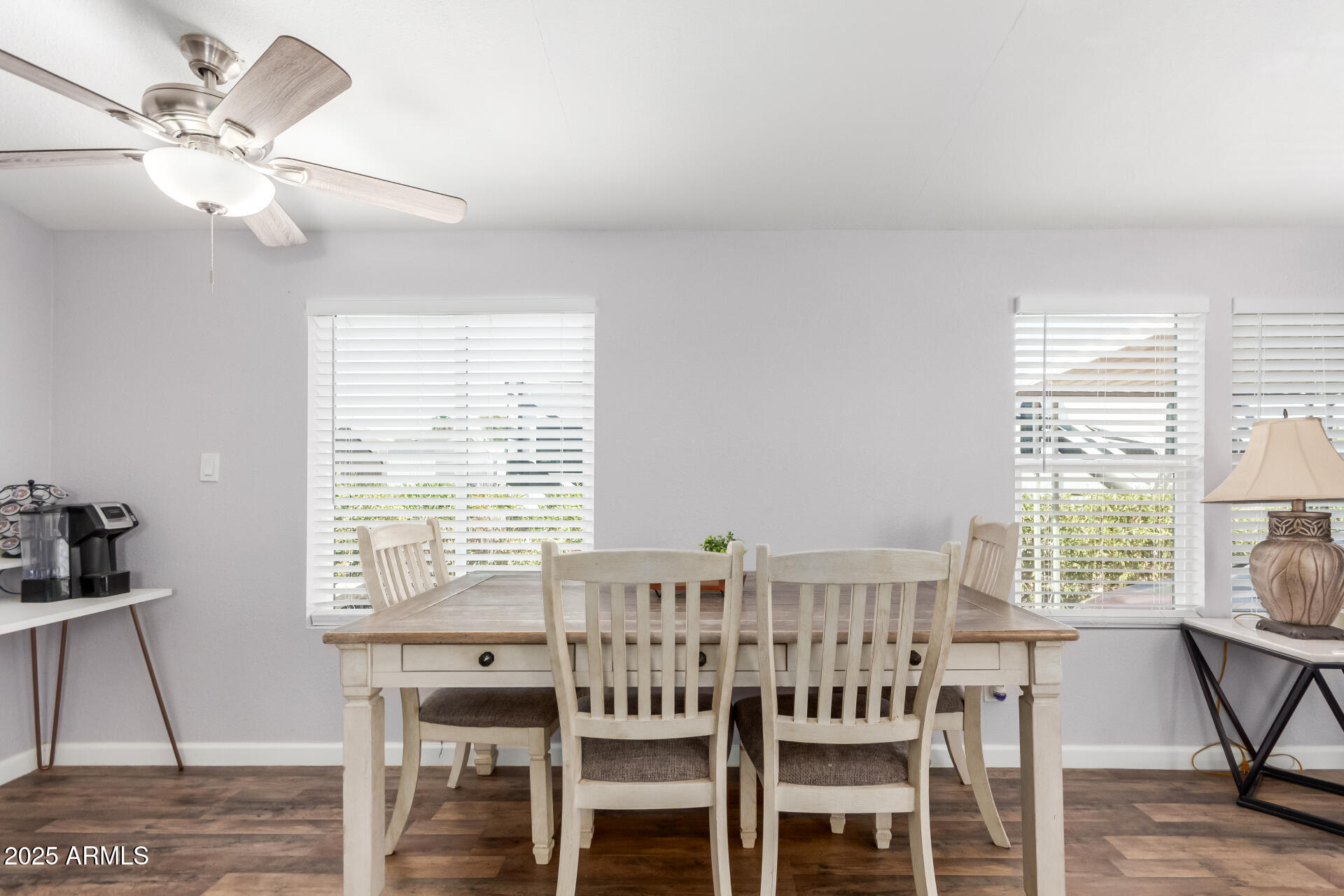 320 East McKellips Road, Unit 188 Mesa, AZ 85201 - Photo 10 of 28 a view of a a dining room with furniture window and wooden floor