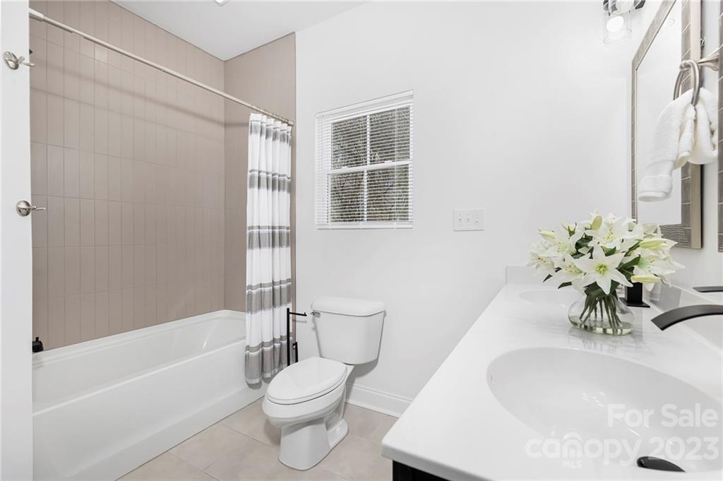 20 Rose Street York, SC 29745 - Photo 13 of 22 a bath room with a toilet a sink and a bath tub