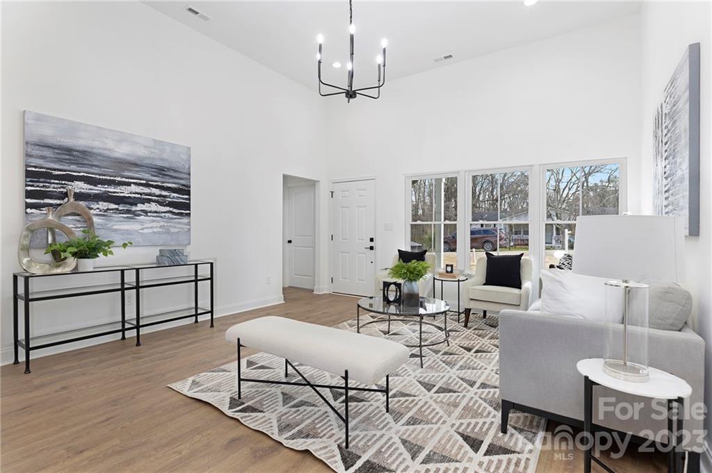 20 Rose Street York, SC 29745 - Photo 2 of 22 a living room with furniture a dining table and a chandelier