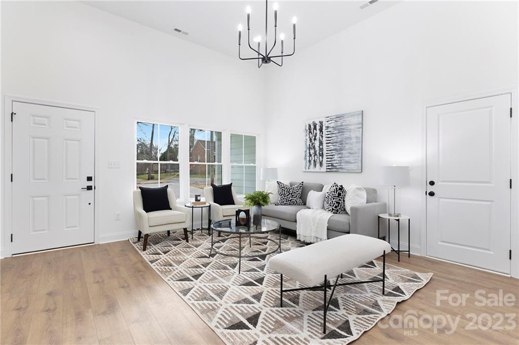 20 Rose Street York, SC 29745 - Photo 3 of 22 a living room with furniture a chandelier and a rug