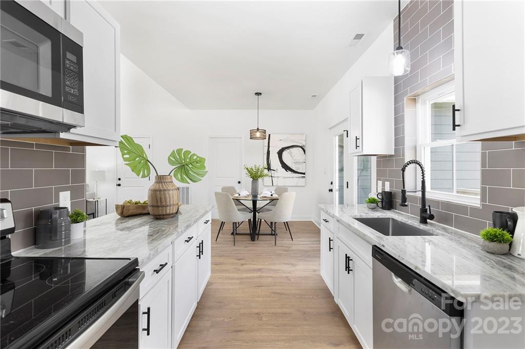 20 Rose Street York, SC 29745 - Photo 6 of 22 a large kitchen with stainless steel appliances a sink a counter space and a view of living room