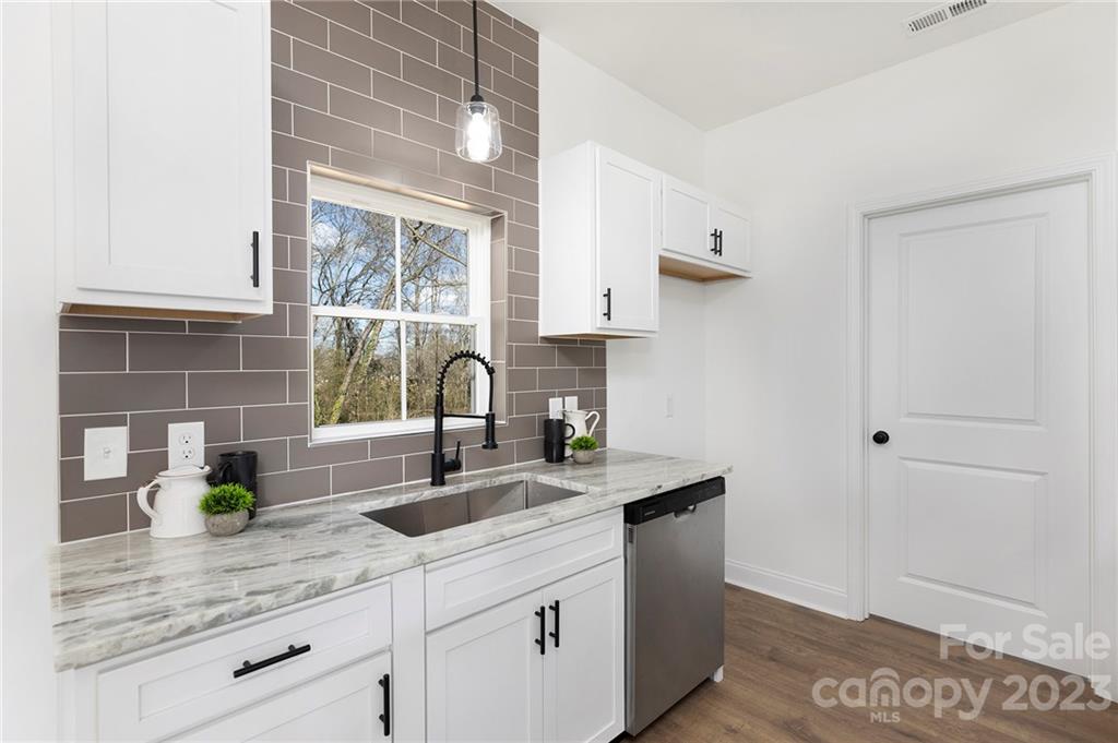 20 Rose Street York, SC 29745 - Photo 7 of 22 a kitchen with stainless steel appliances granite countertop a sink a stove and a window