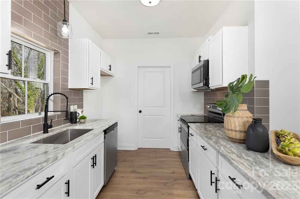 20 Rose Street York, SC 29745 - Photo 8 of 22 a kitchen with granite countertop a sink and a stove top oven