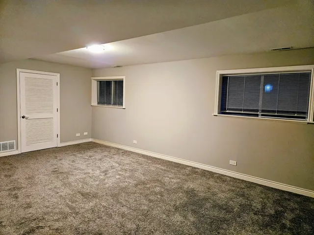 a balcony with furniture and umbrella