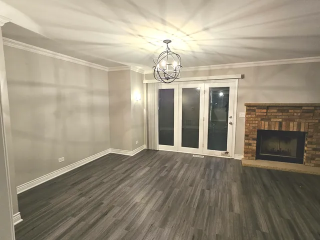 wooden floor in an empty room with a fireplace