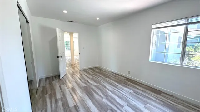 a view of wooden floor and windows in a room