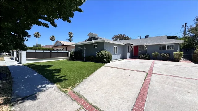 a view of a white house with a yard