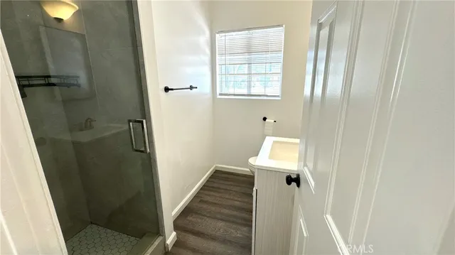 a view of a bathroom with wooden floor and windows