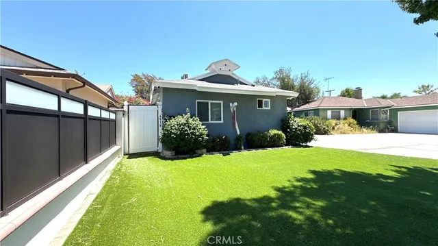 a view of a house with a yard and plants