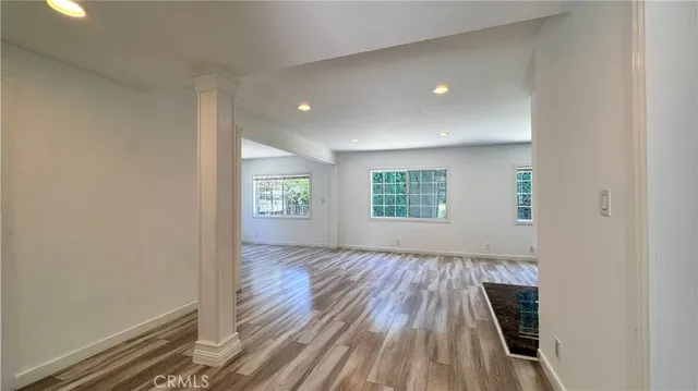 wooden floor in an empty room with a window