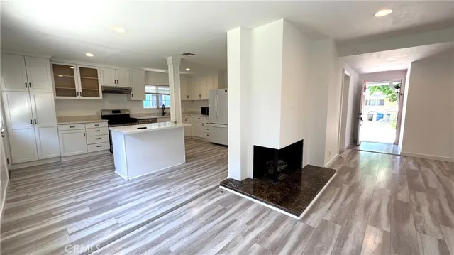 a kitchen with stainless steel appliances granite countertop a stove a refrigerator a sink and a microwave