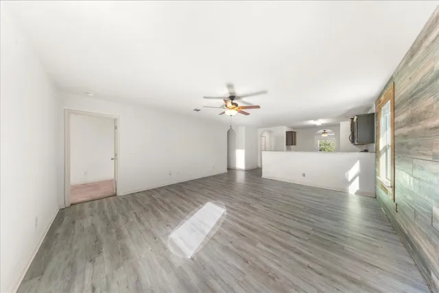 wooden floor in an empty room with a window