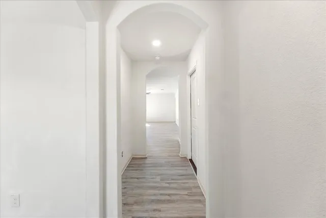 a view of a hallway with wooden floor