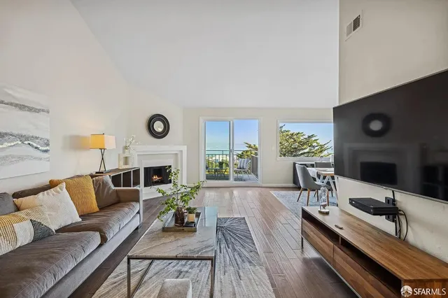 a living room with furniture fireplace and window