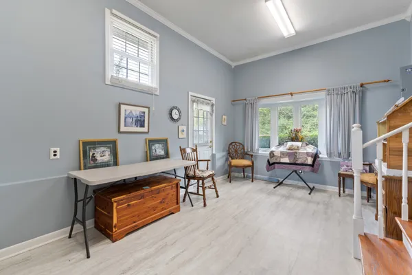 a living room with furniture a rug and a window