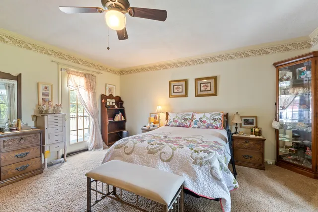 a bedroom with a bed dresser and a large mirror