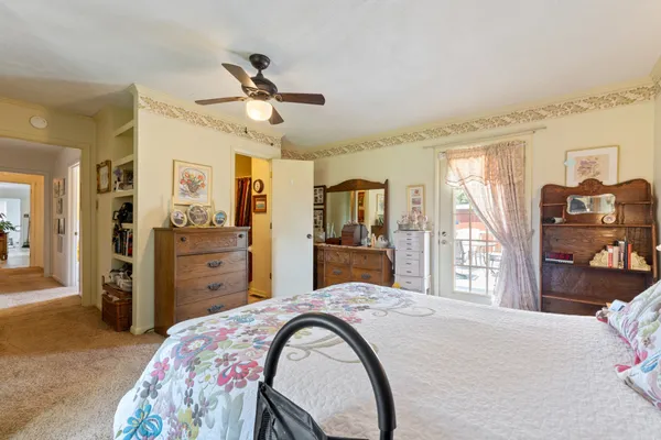 a bedroom with a bed and a chandelier