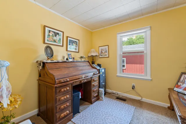 a living room with furniture and a wall painting