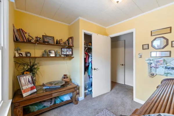 a bedroom with a bed a couch and dresser