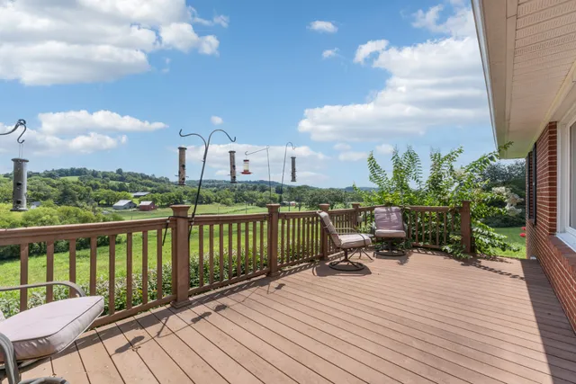 a view of a chairs and table on the roof deck