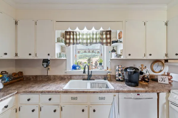 a kitchen with lots of counter top space and wooden floor