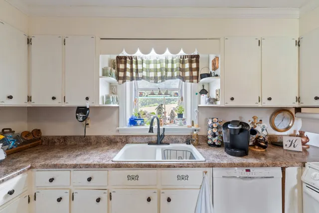 a kitchen with lots of counter top space and wooden floor