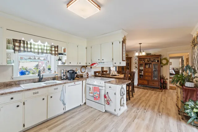 a living room with furniture and a kitchen