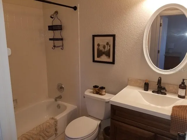 a bathroom with a toilet a sink and bathtub
