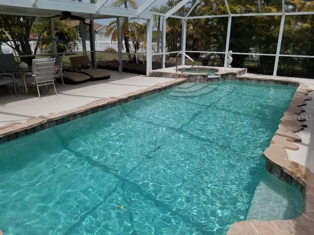 a view of a chair and tables in the back yard