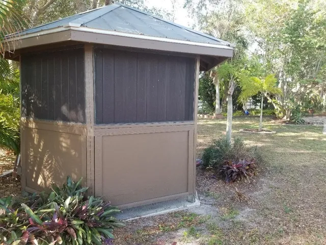 a backyard of a house with plants and trees