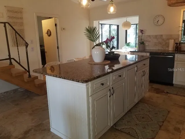 a kitchen with sink and mirror