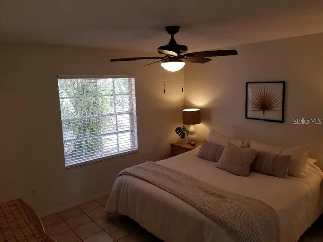 a bedroom with a bed and a window