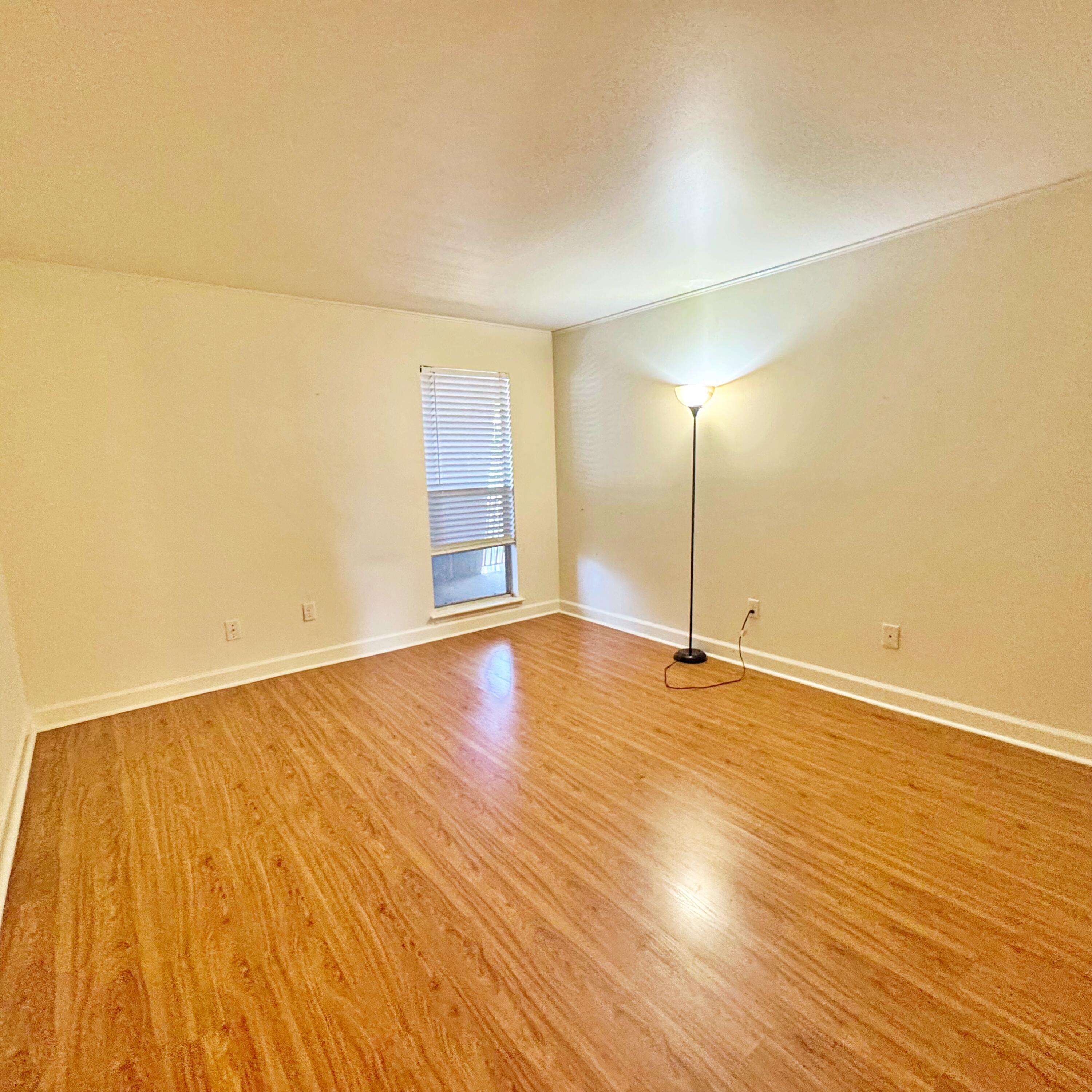 210 Pelham Road, Unit 215B Fort Walton Beach, FL 32547 - Photo 18 of 23 an empty room with wooden floor and windows