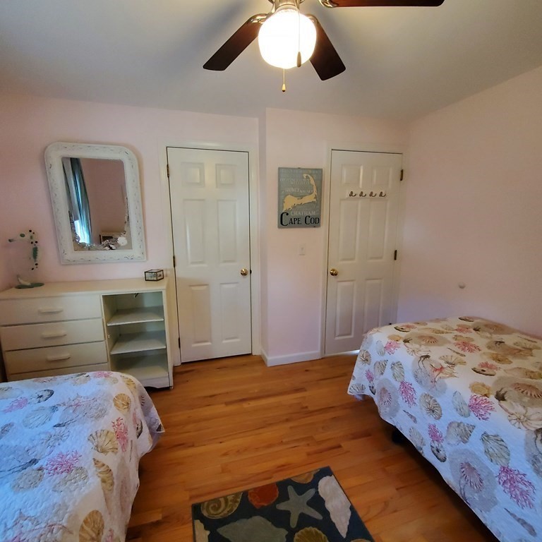45 Nipigon Way West Dennis, MA 02639 - Photo 26 of 42 a bedroom with a bed and a chandelier