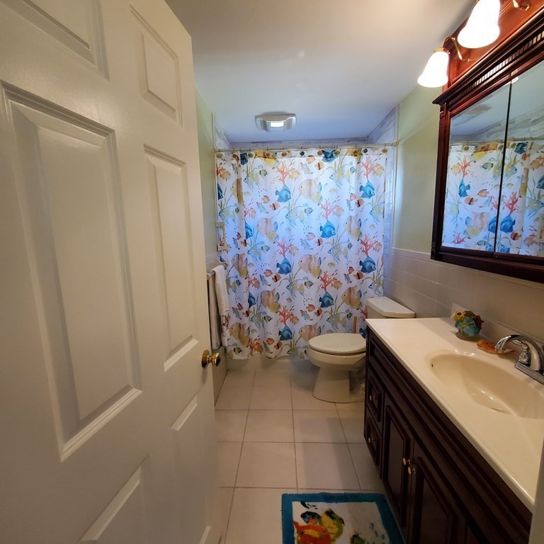 45 Nipigon Way West Dennis, MA 02639 - Photo 29 of 42 a bathroom with a sink a toilet and shower curtain