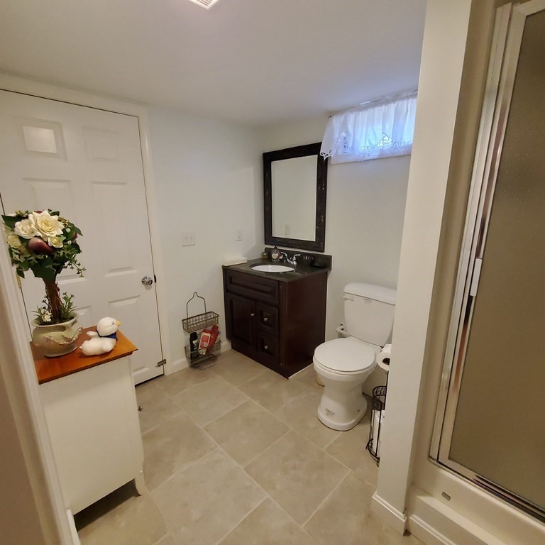 45 Nipigon Way West Dennis, MA 02639 - Photo 36 of 42 a bathroom with a toilet sink and mirror