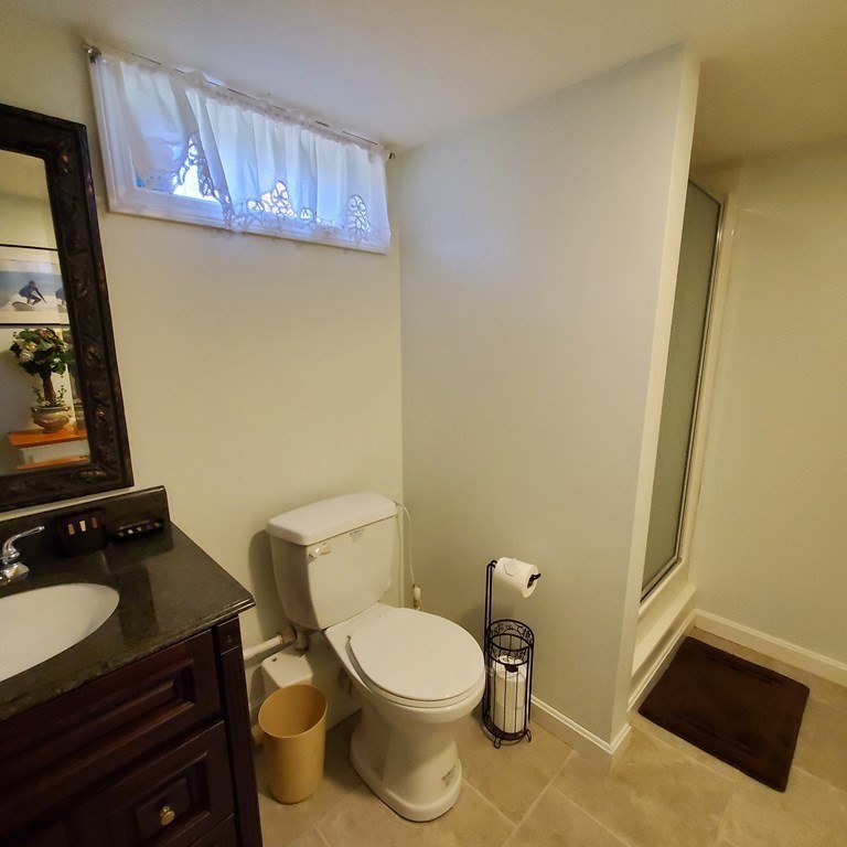45 Nipigon Way West Dennis, MA 02639 - Photo 38 of 42 a bathroom with a toilet a sink and mirror