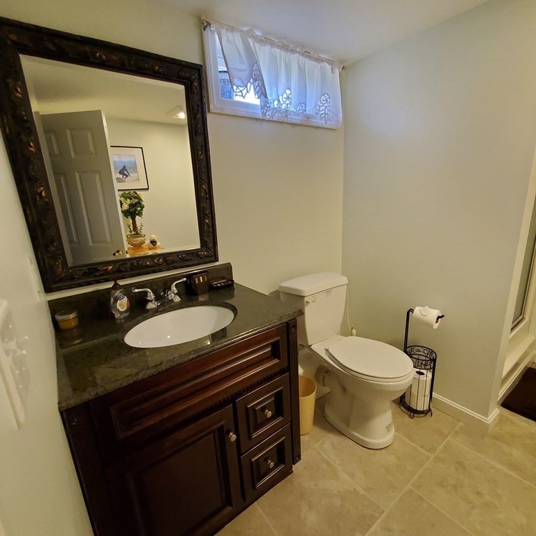 45 Nipigon Way West Dennis, MA 02639 - Photo 39 of 42 a bathroom with a toilet sink and mirror