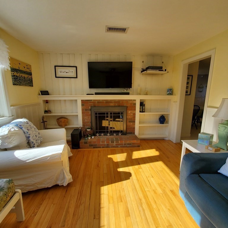 45 Nipigon Way West Dennis, MA 02639 - Photo 6 of 42 a living room with furniture and a flat screen tv