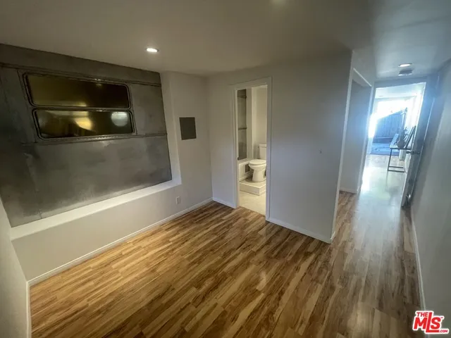 a view of a patio with table and chairs potted plants with wooden fence