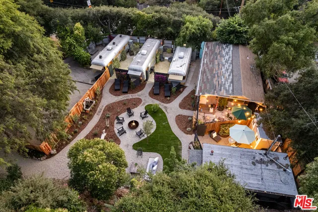 an aerial view of a house with a yard and lake view