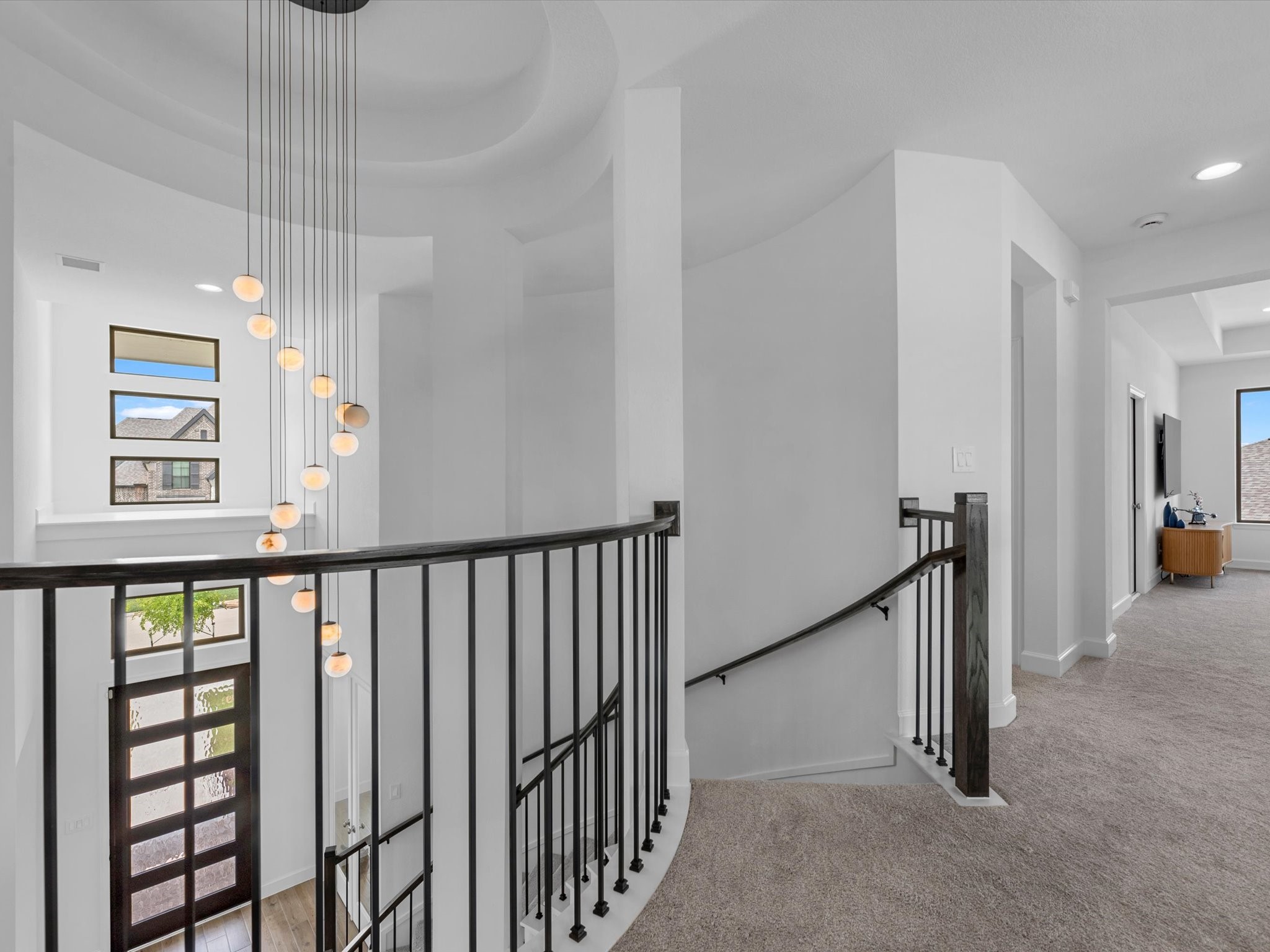18714 Pistachio Way Manvel, TX 77578 - Photo 27 of 48 The upstairs landing offers a beautiful perspective of the home's soaring ceilings, designer chandelier, and the spacious game room just beyond.