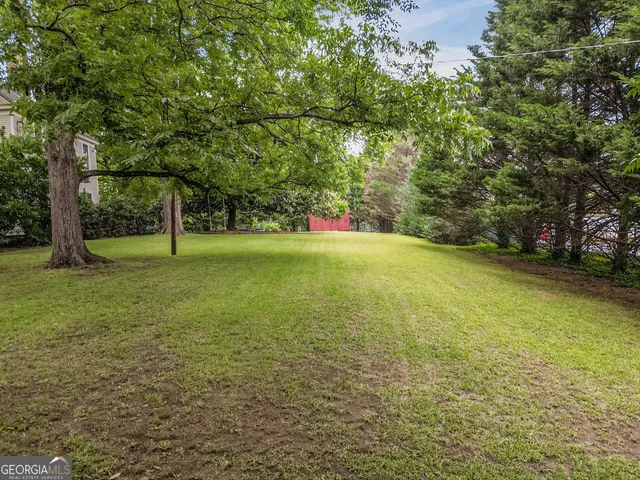 a view of field with trees in the background